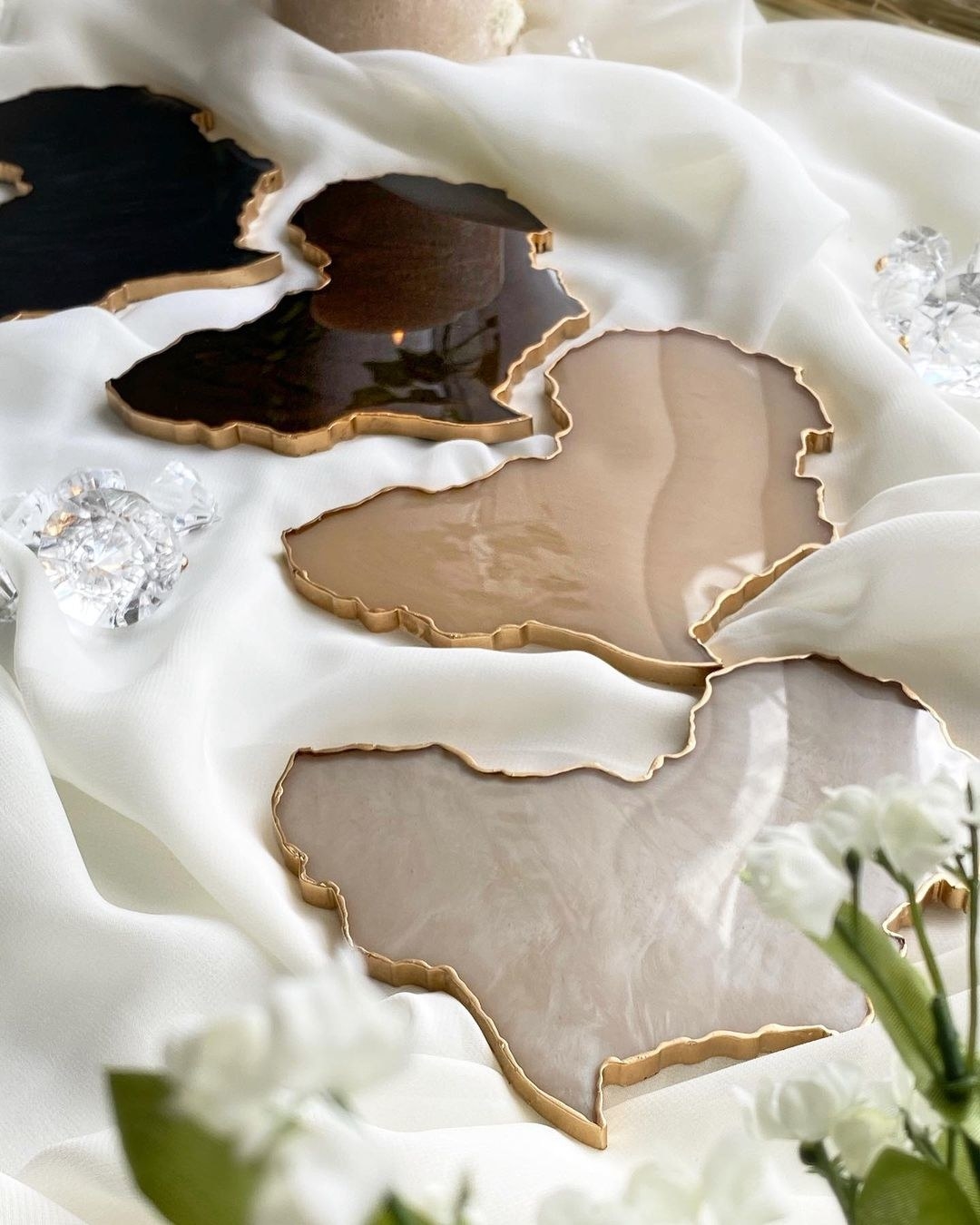 the Africa-shaped coasters in shades of brown and black with gold trim