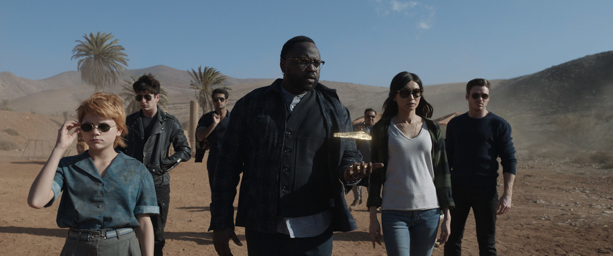 The cast of Eternals walking through a desert
