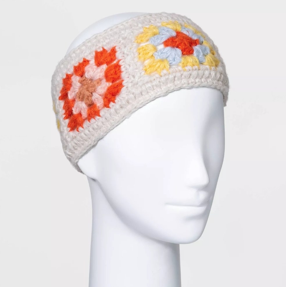 White knitted headband with orange, blue and yellow flower embroidery