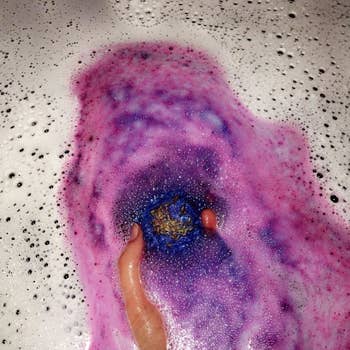 Reviewer placing bath bomb in water