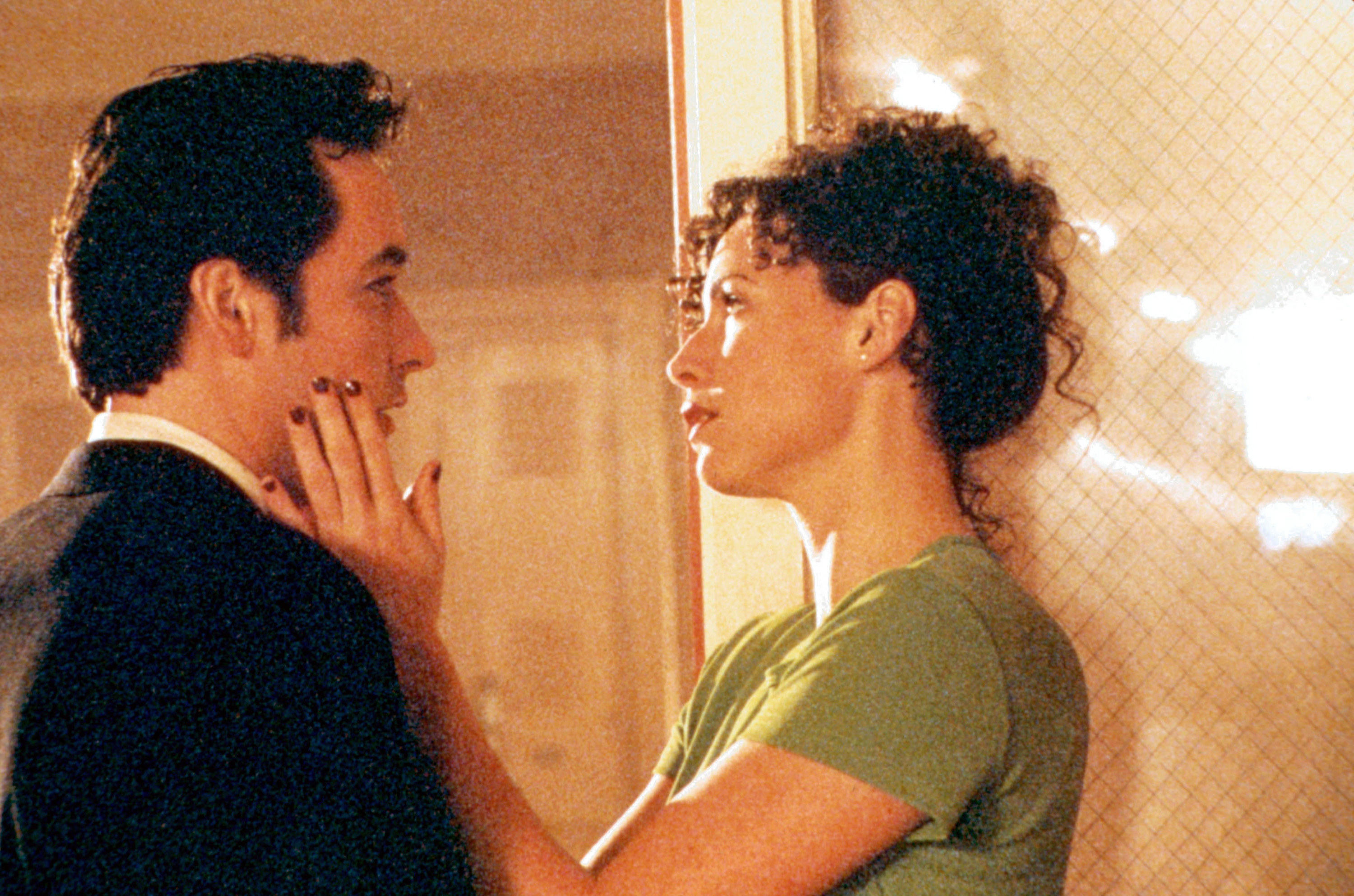 John Cusack&#x27;s face being held by Minnie Driver.