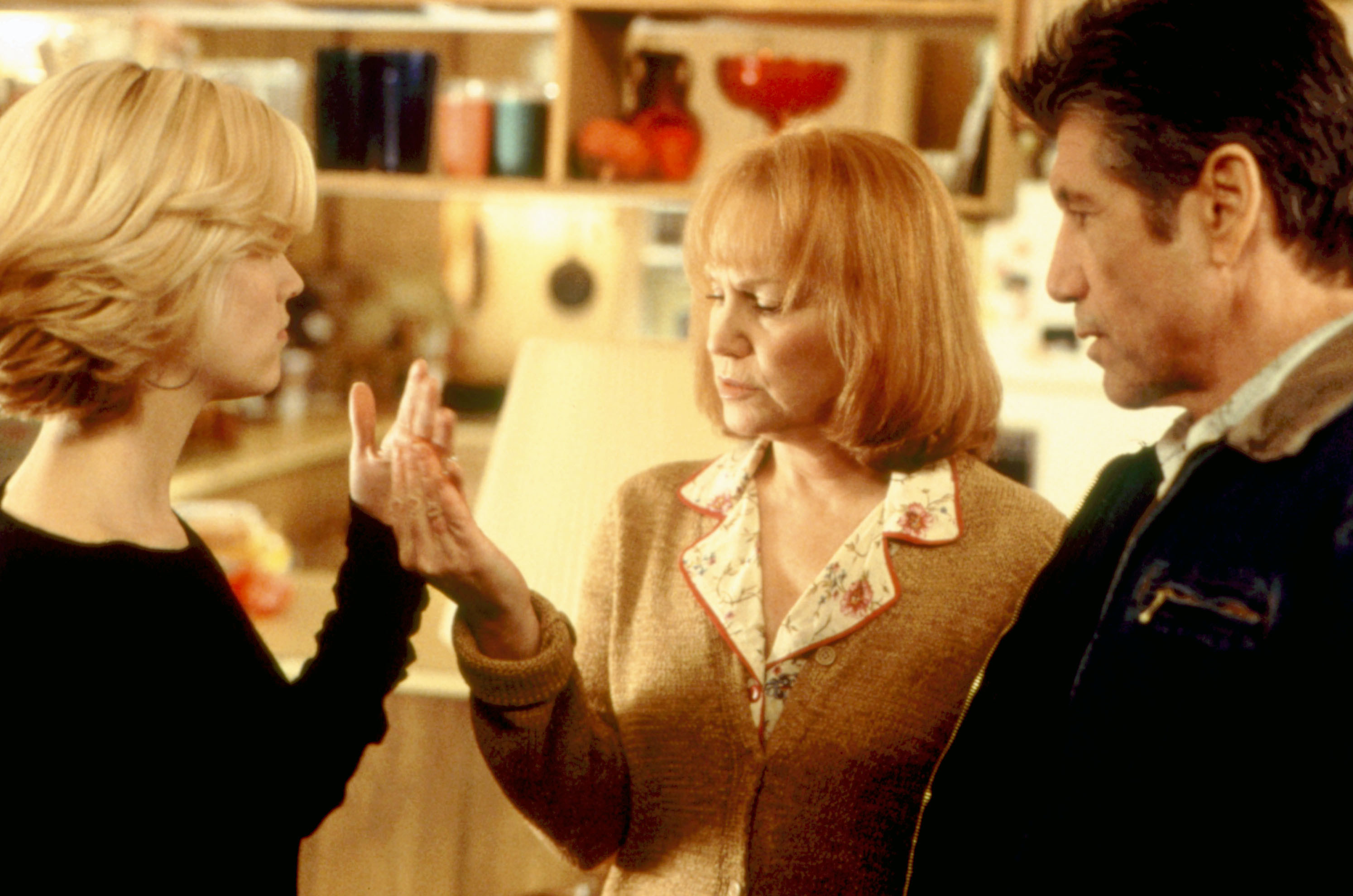 Reese Witherspoon showing her hand to Mary Kay Place and Fred Ward.