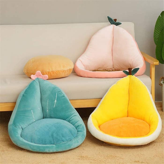 the pear-shaped cushion on the couch and on the floor