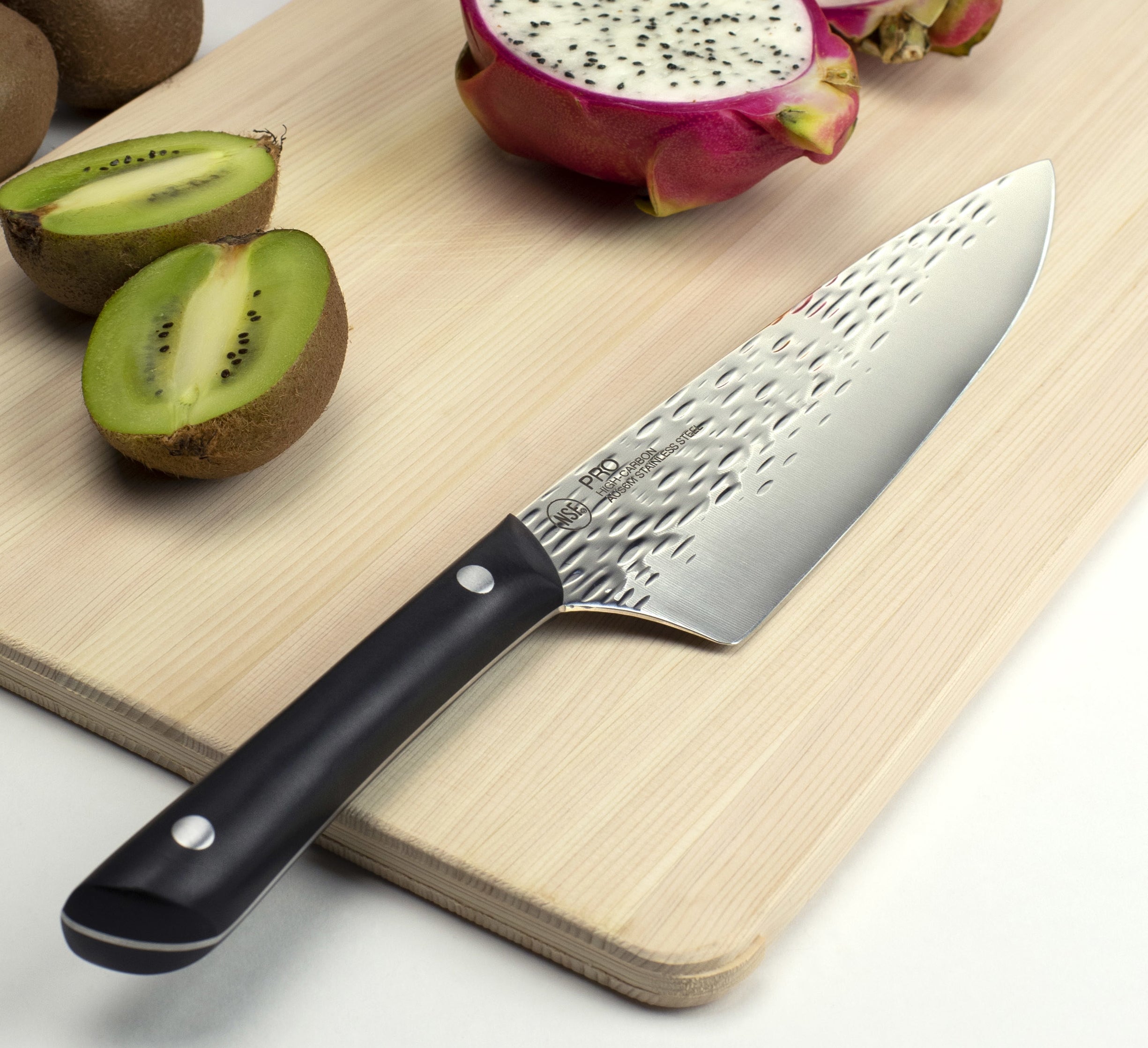 A Kai Pro knife on a cutting board.