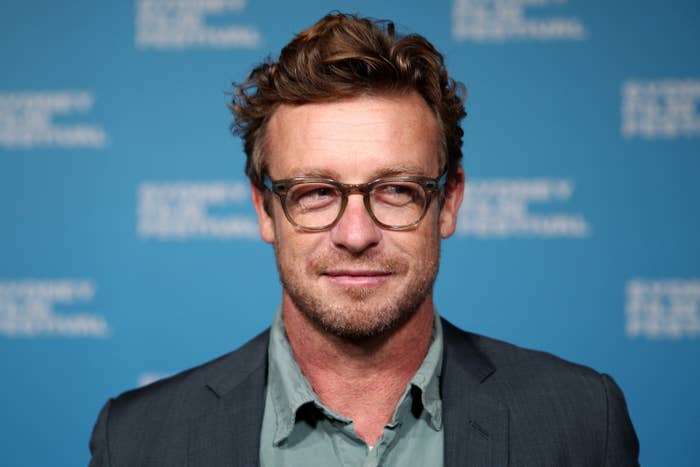 Simon Baker smiles for a photo at an event