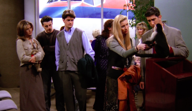 Joey, Rachel, Chandler, Phoebe, and Ross saying by to Marcel the monkey inside an airport