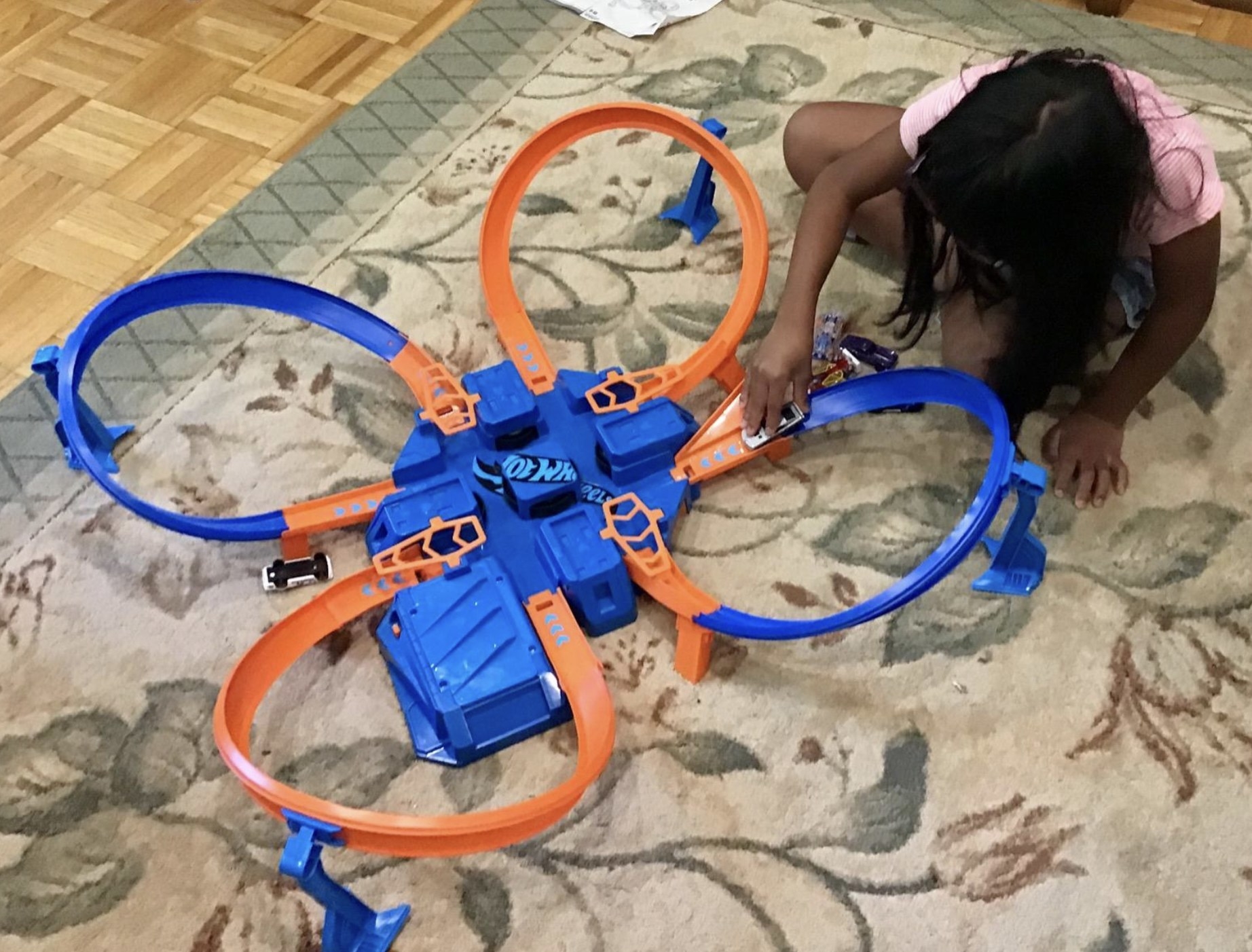 a child playing with the blue and orange criss criss crash track set