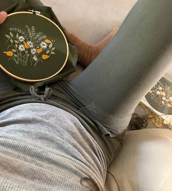 a reviewer shows their completed floral embroidery hoop