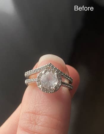 reviewer shows their foggy diamond ring before using the cleaning pen