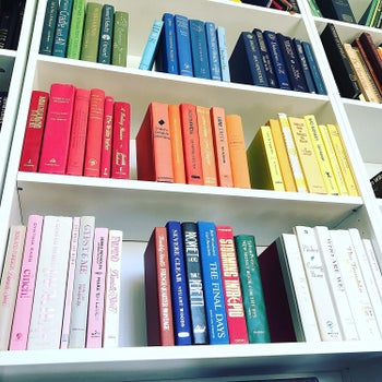 groups of color-coded books on a bookshelf