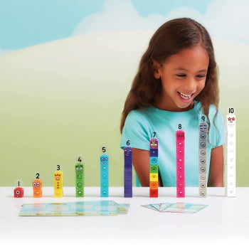 A child looking at towers of colorful cubes