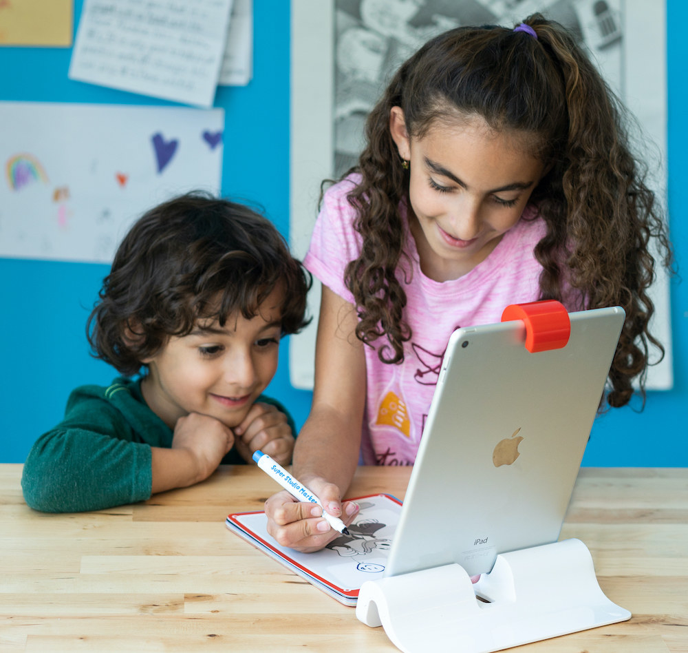 Young girl and boy using Osmo&#x27;s Super Studio Artist Bundle