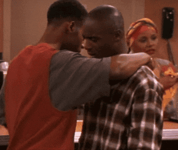 Omar and Hakeem are hugging, while Moesha sits on stage reciting a poem.