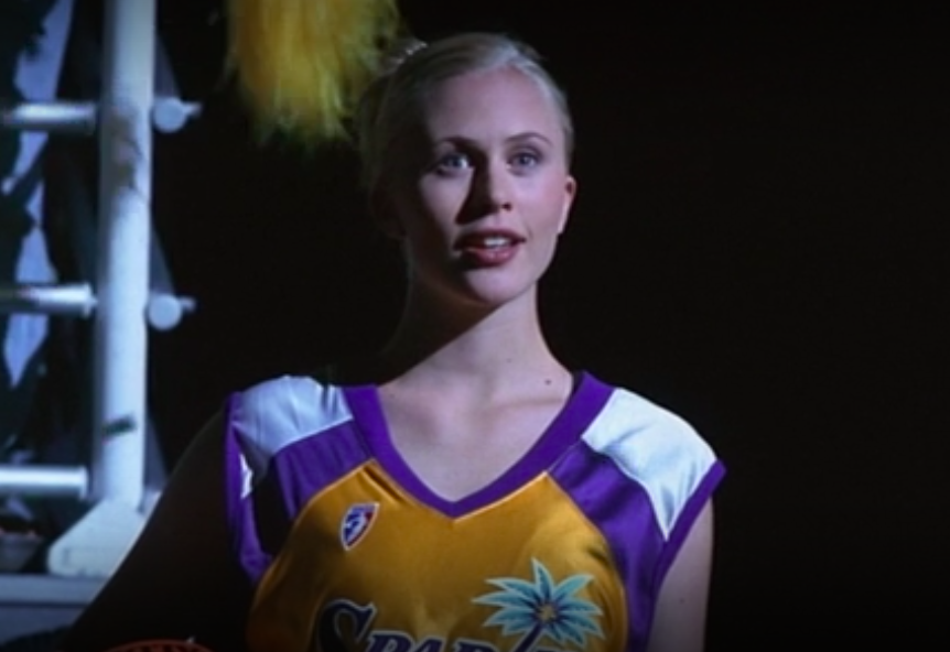 Annie McElwain in a basketball uniform with her blonde hair tied up