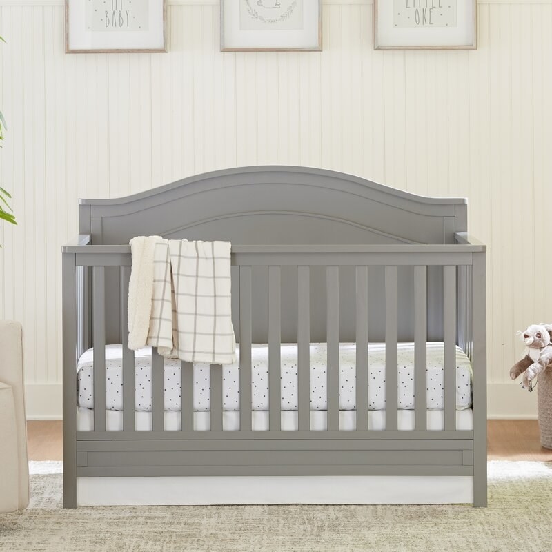 the grey crib in a nursery