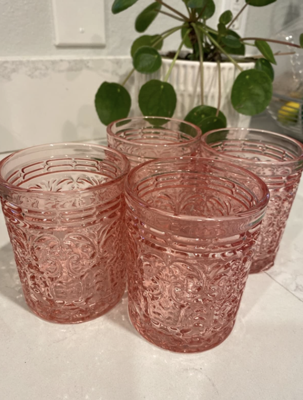 pink crystal cocktail glasses with intricate designs on the outside