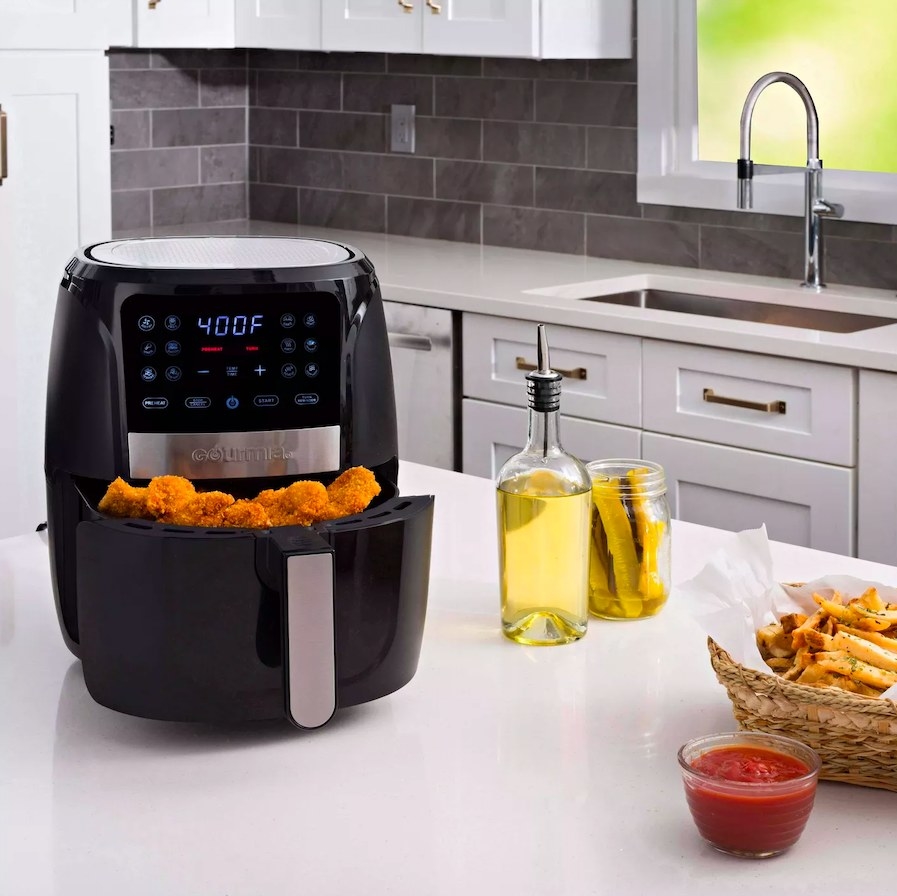 Air fryer holding friend chicken, sitting on a countertop