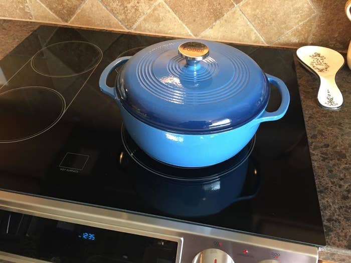 reviewer image of the blue dutch oven on an oven top