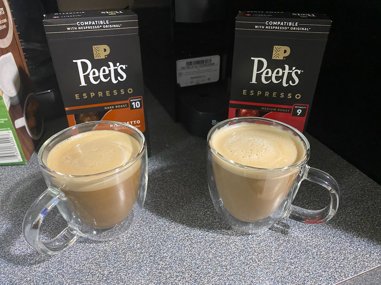the two espresso cups holding coffee in them in front of two peet&#x27;s espresso bags