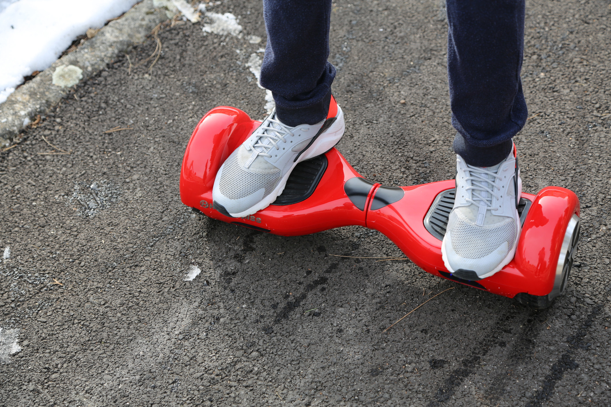 Someone rides a hoverboard outside during winter