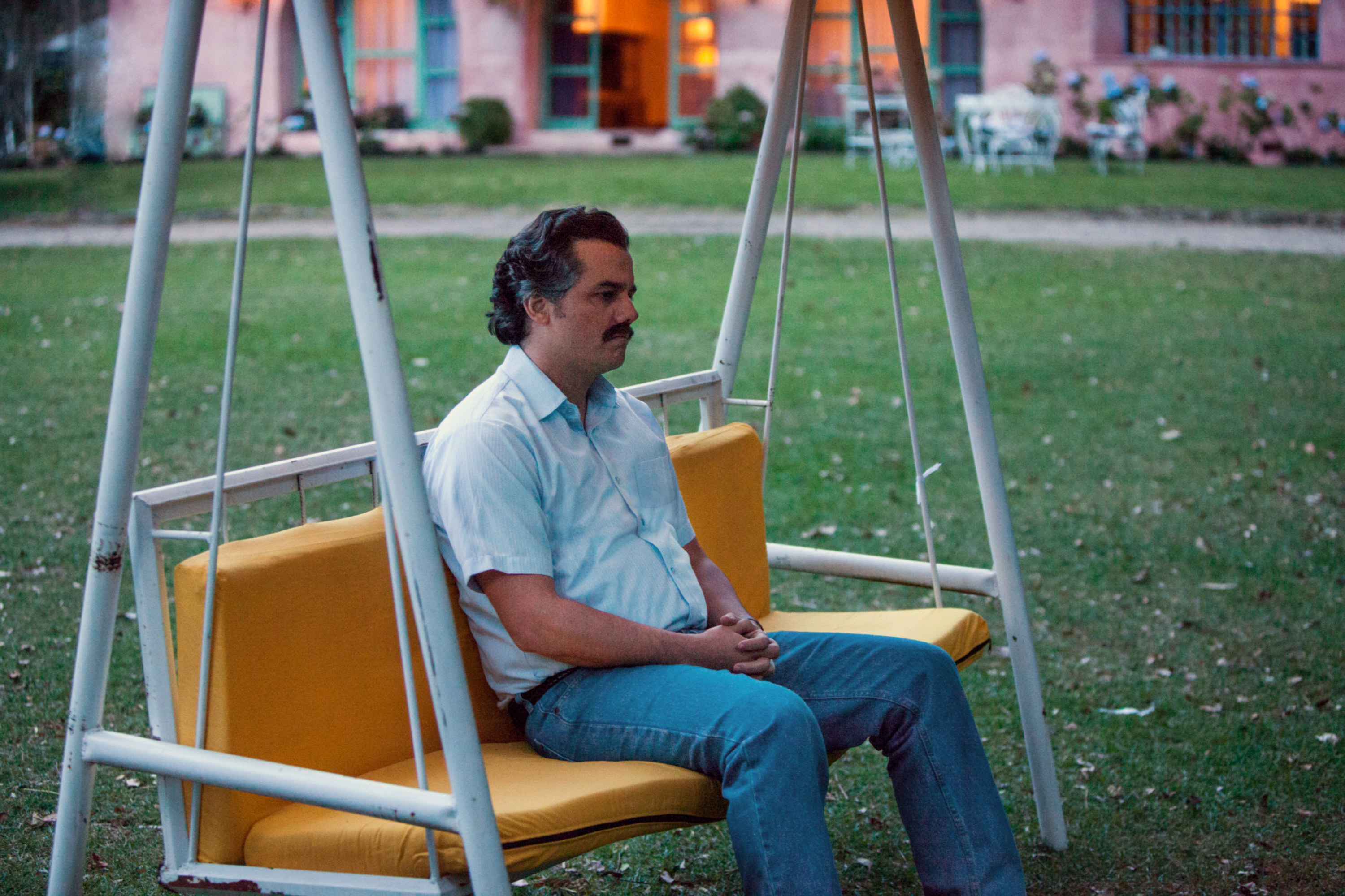 Moura as Escobar on a swing