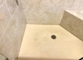 reviewer image of dirty and stained shower floor