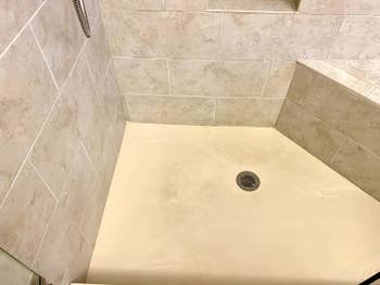 reviewer's dirty and stained shower floor
