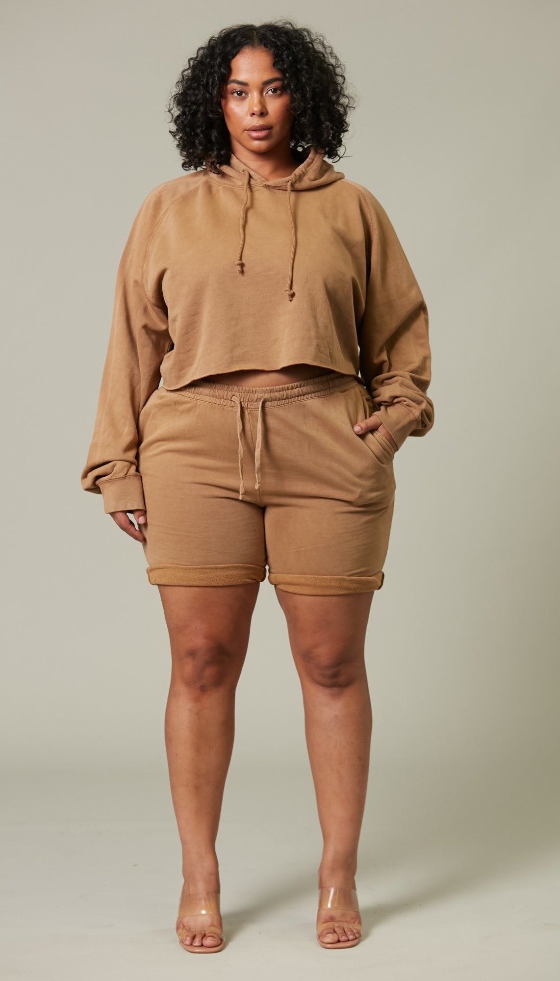Model is wearing a brown hoodie and shorts set