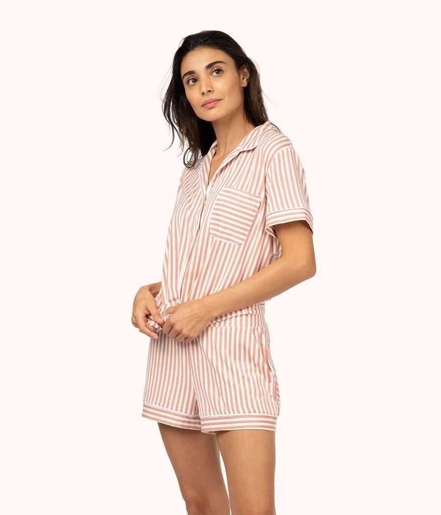 a model in light pink pajamas with vertical stripes