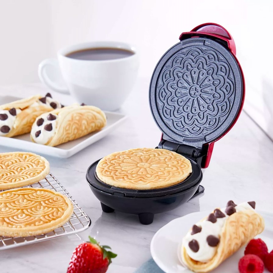 Pizzelle maker and baked pizzelles shown