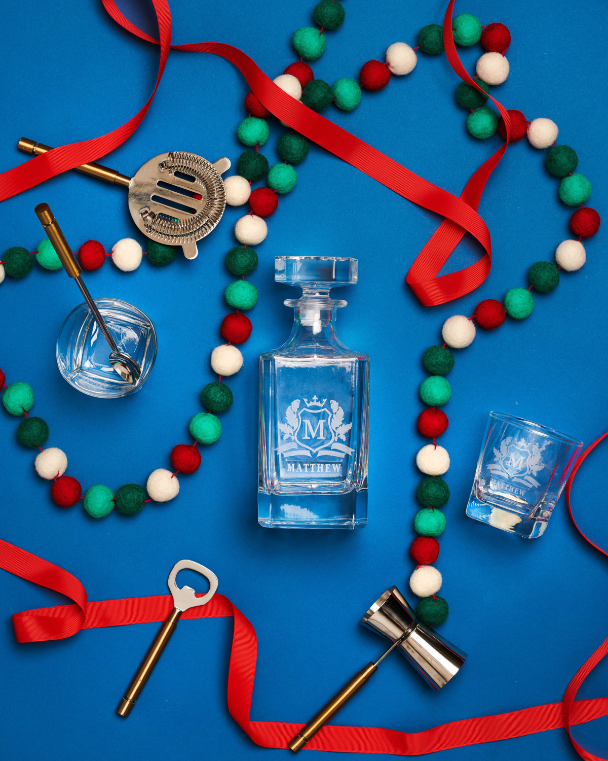Monogrammed whiskey decanter and glasses featured in holiday flat lay