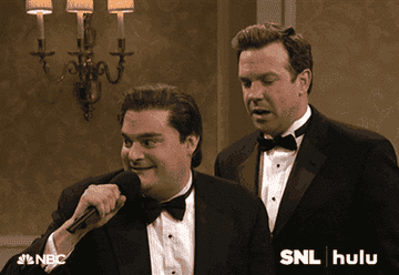 bobby moynihan dropping a mic next to jason sudeikis on SNL