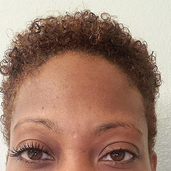 a reviewer with mascara on their left eye