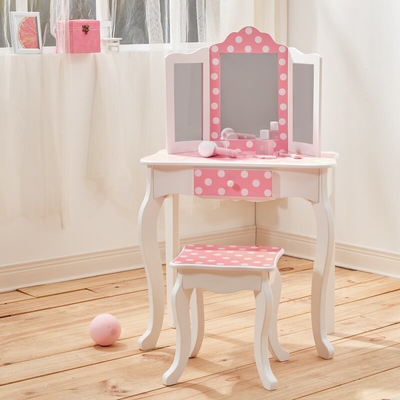 the white and polka dotted vanity in a plain room