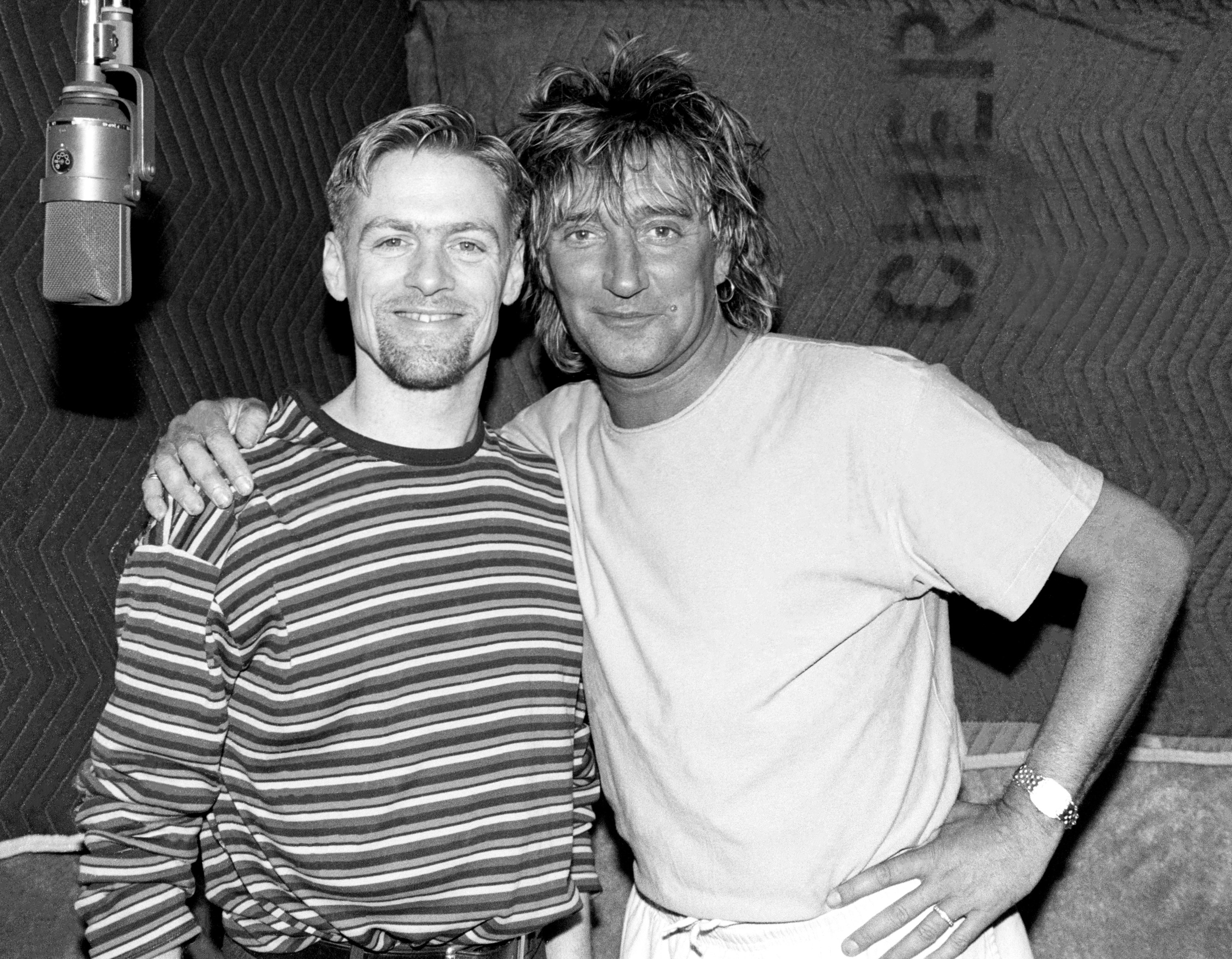 Canadian guitarist, singer, composer, record producer, photographer, and philanthropist Bryan Adams and British rock and pop singer, songwriter, and record producer Rod Stewart pose for a portrait while in studio recording a song