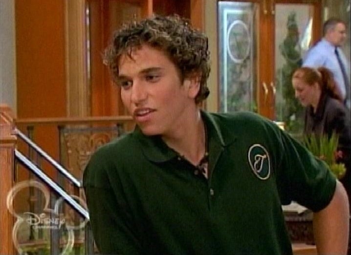 Aaron in a Tipton Hotel uniform with short curly hair on &quot;Suite Life&quot;