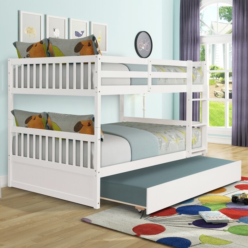 the white bunk bed with the trundle half out
