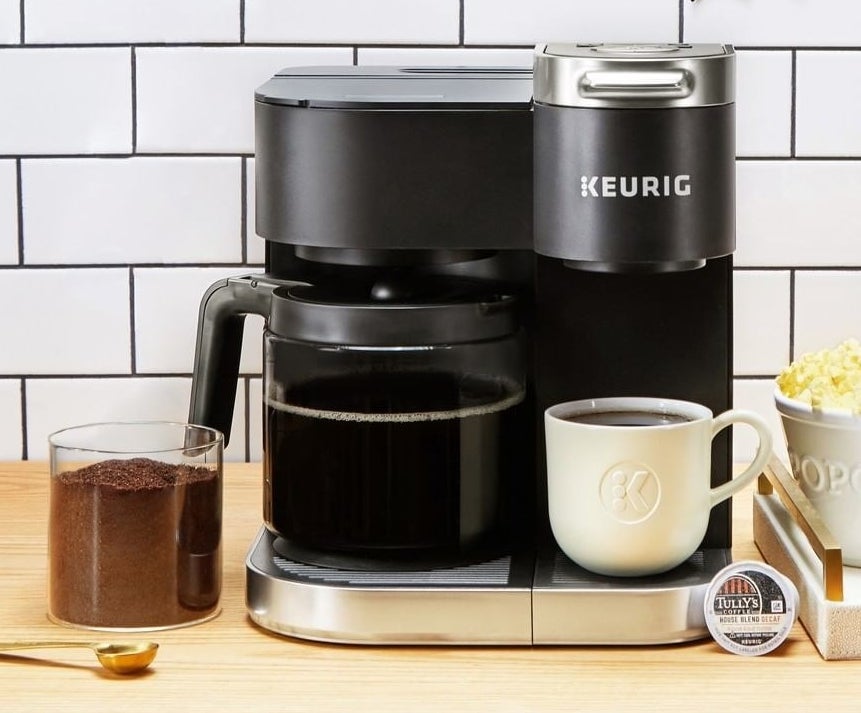 the K-duo brewer with a full carafe of coffee on the left and a mug full of coffee on the right