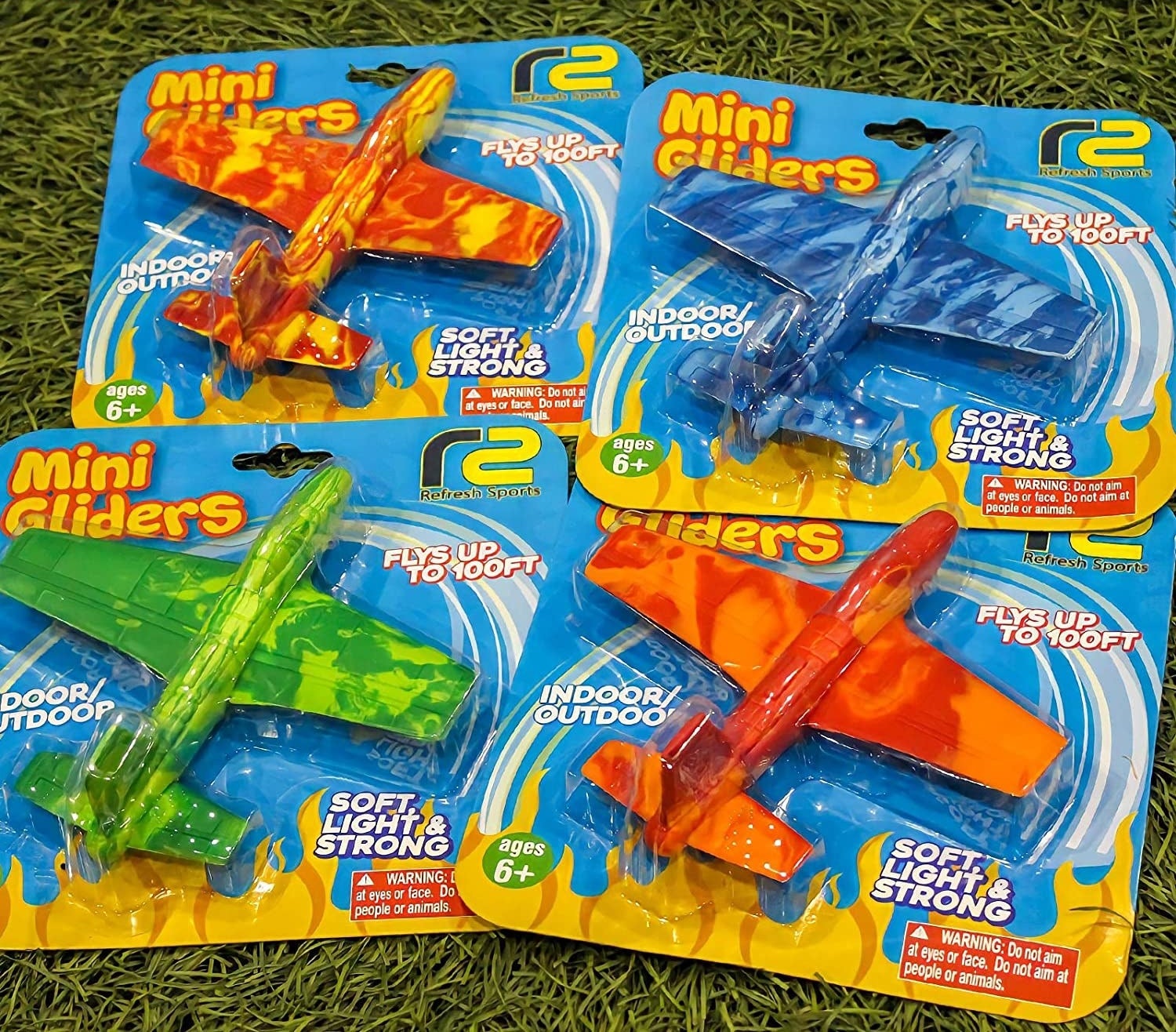 Four multicolored foam plane toys in their packaging
