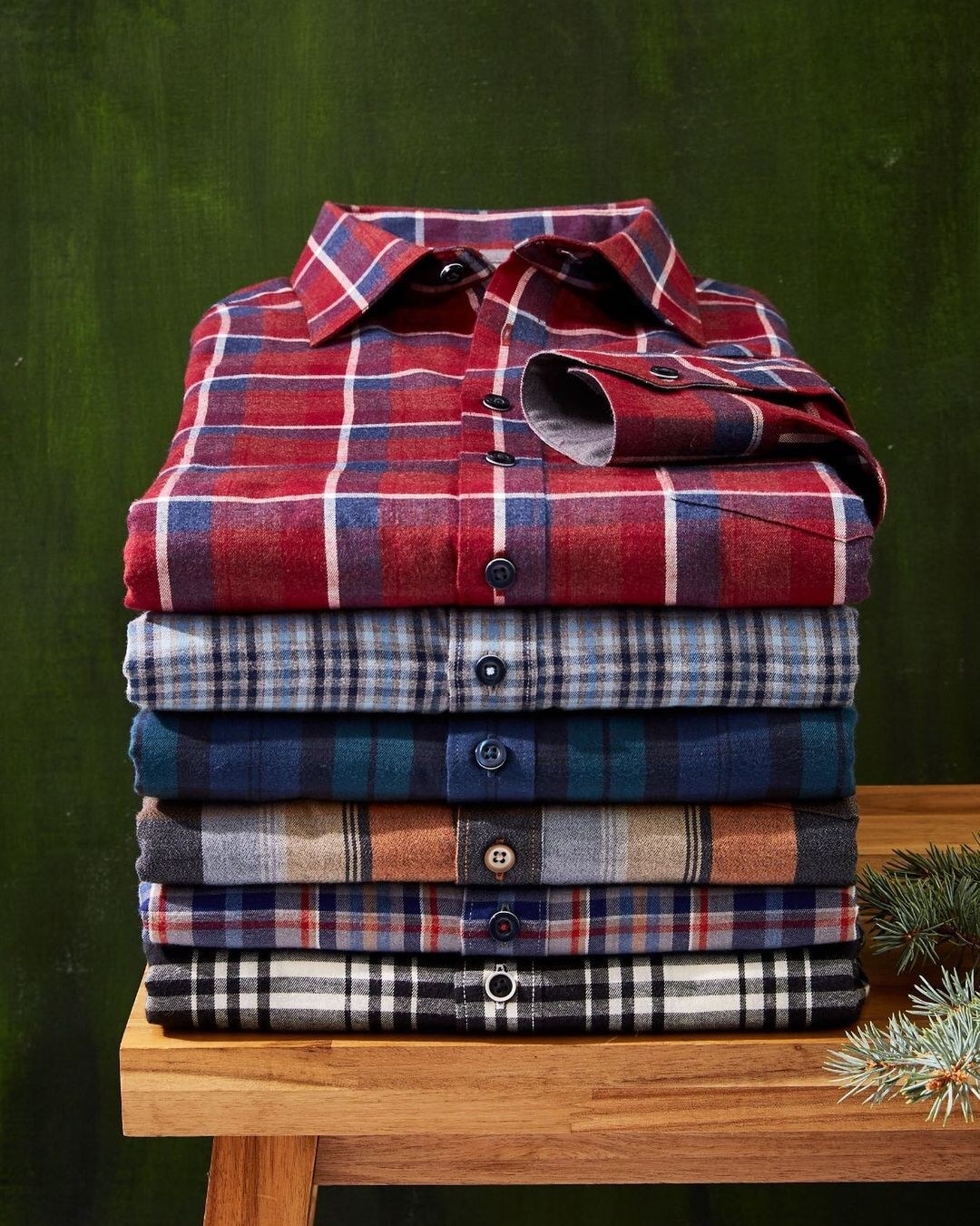a stack of flannel dress shirts