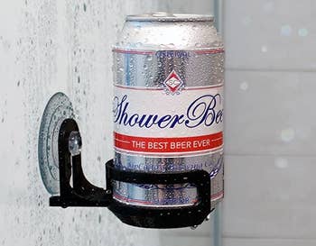 a suction cup caddy in a shower with a can of beer in it