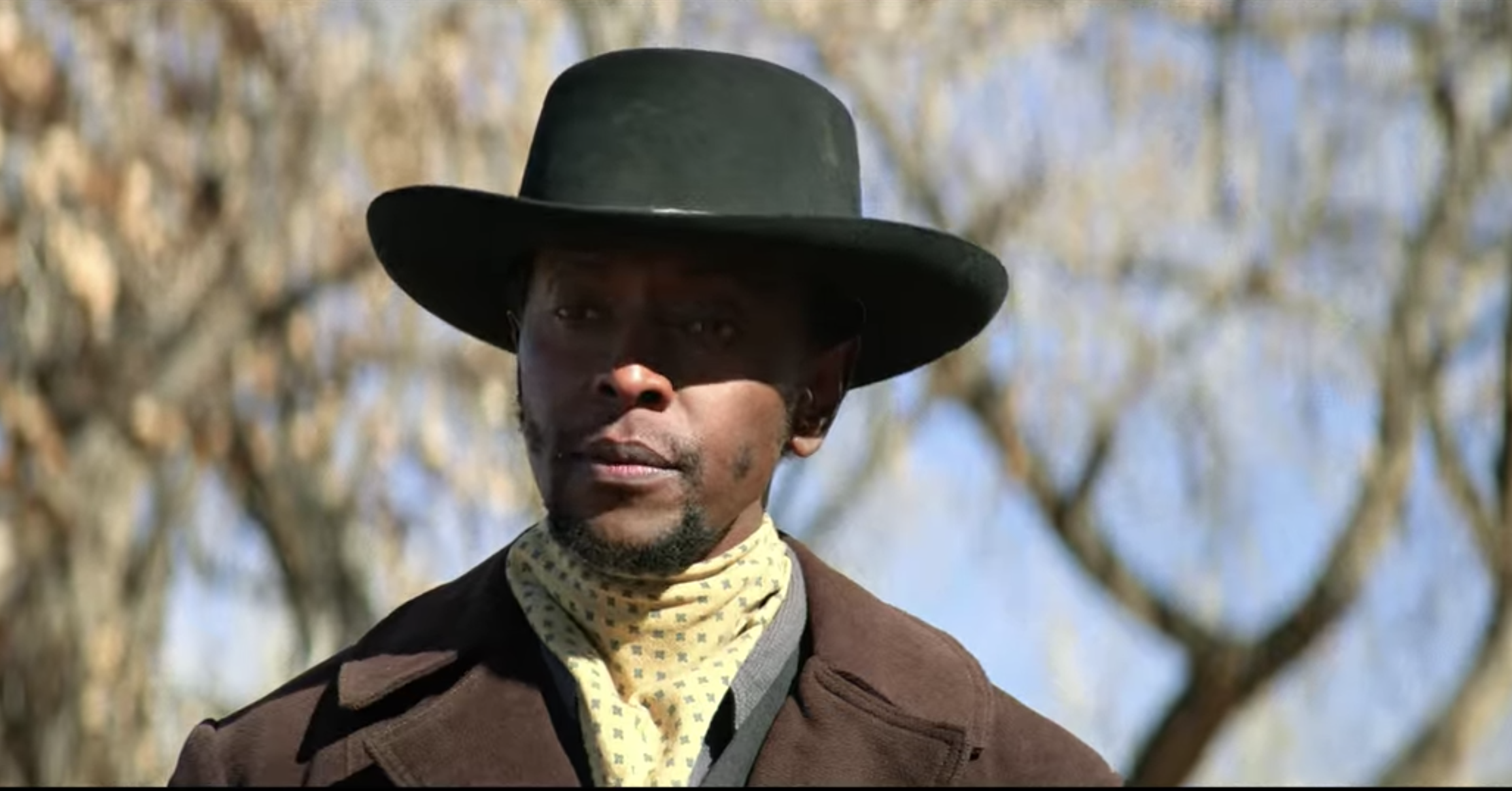 A closeup of Bill Pickett who&#x27;s wearing a cowboy hat