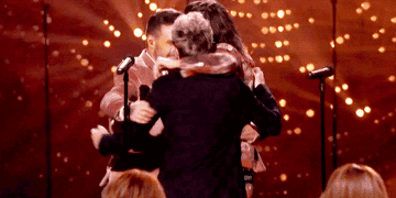 One Direction doing a group hug