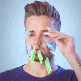 A image of Liam putting on cloth pegs on his face
