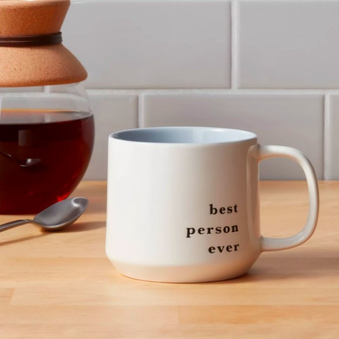 The white mug with black text that says &quot;best person ever&quot;
