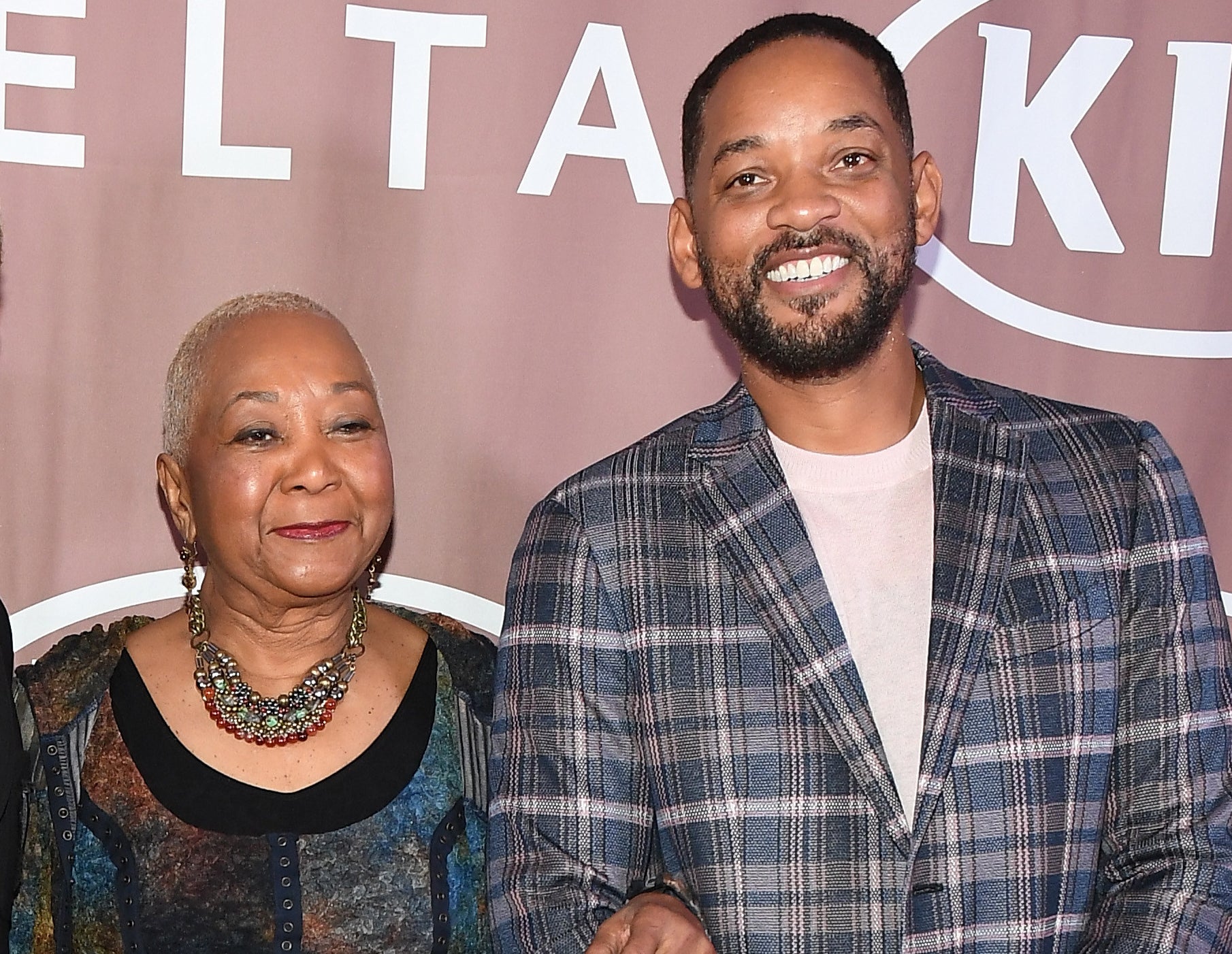 Will poses with his mother at an event