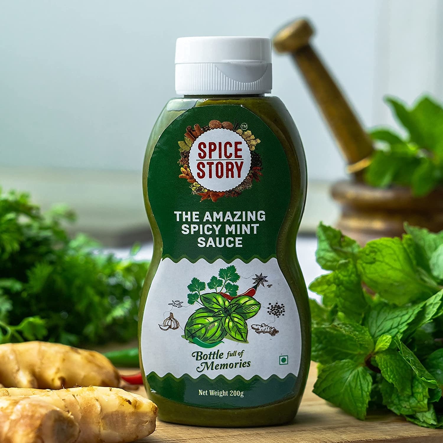 A bottle of the sauce next to herbs and spices