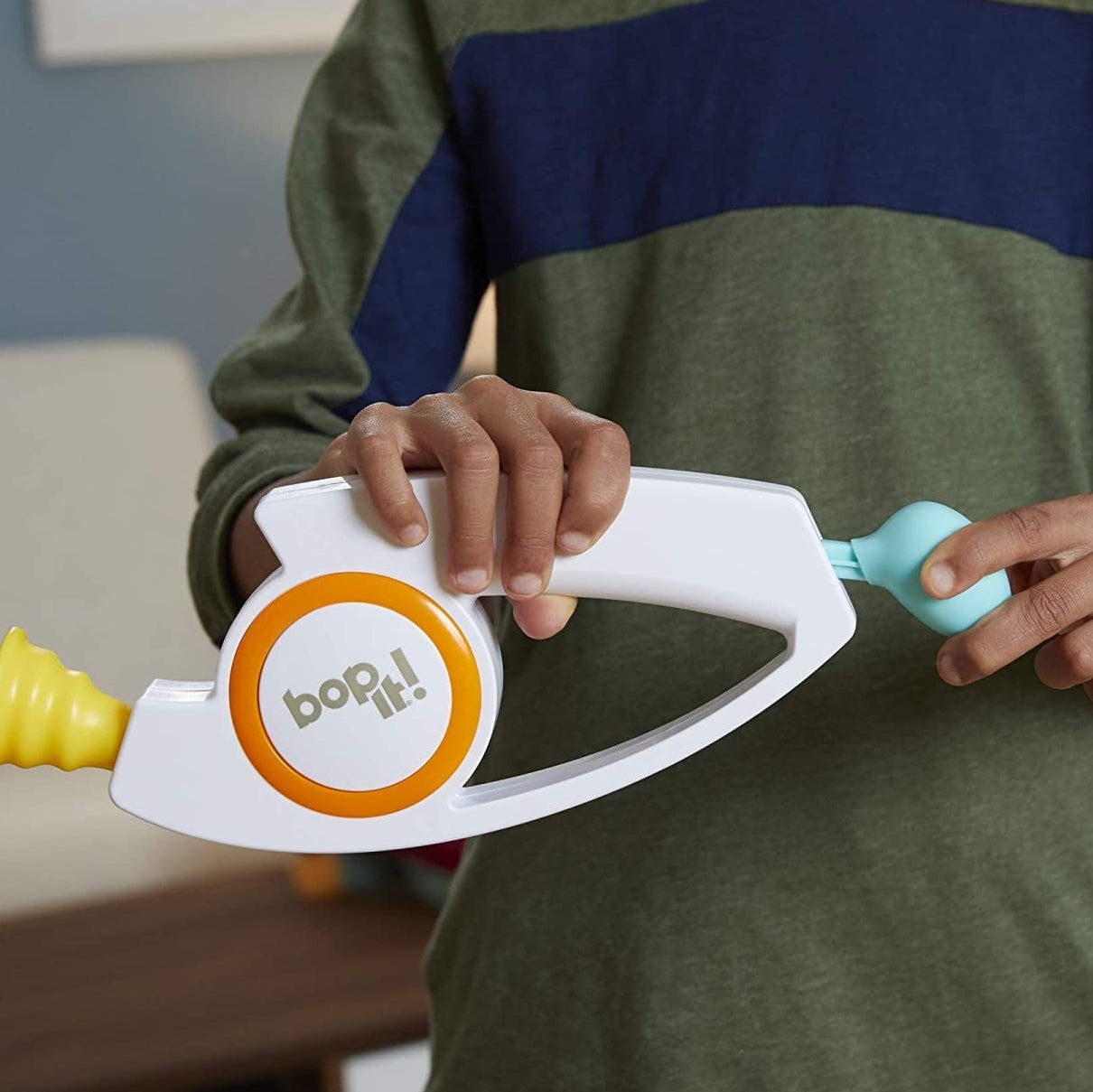 A person holding the Bop It!