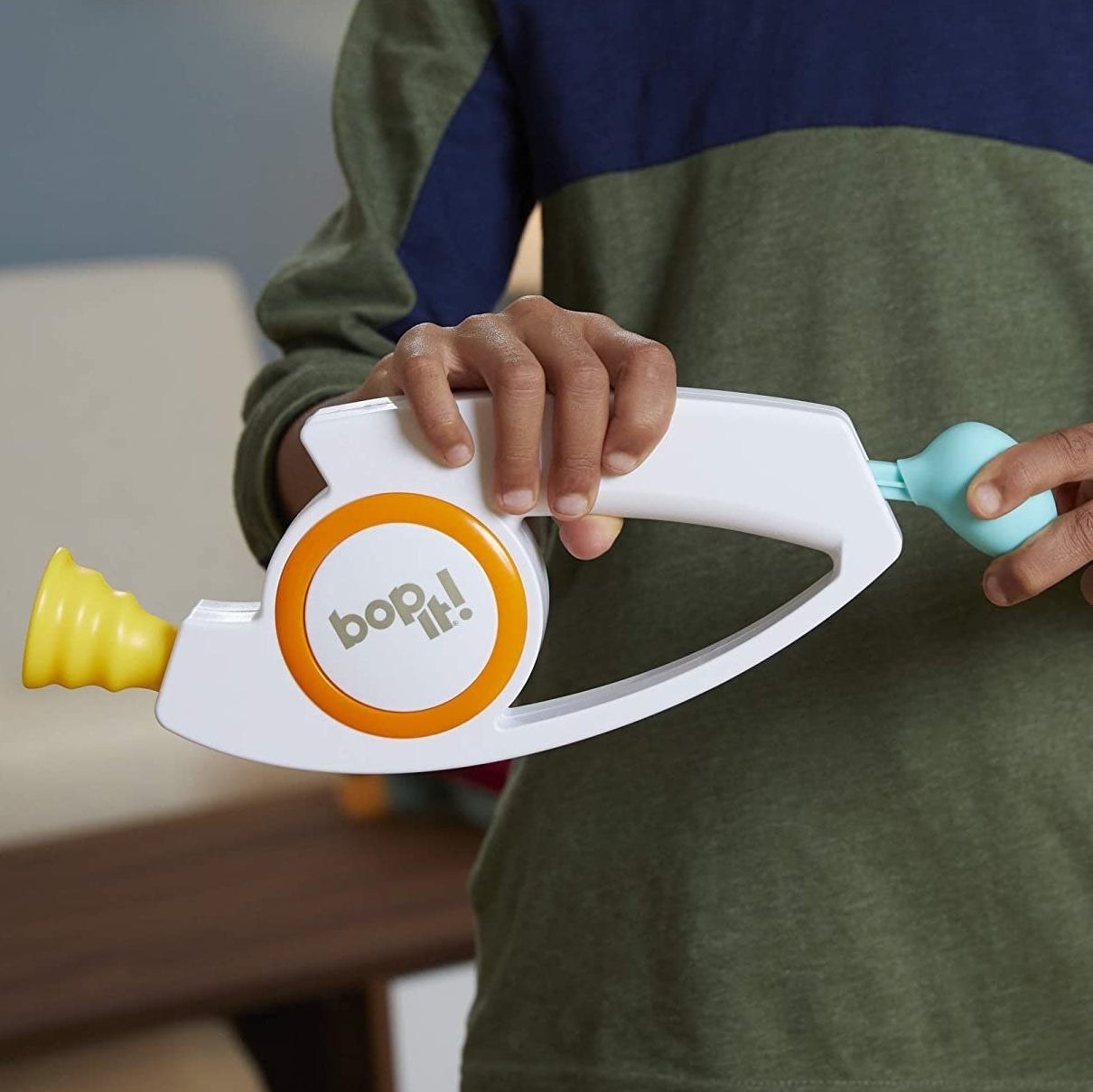 A person holding the Bop It!
