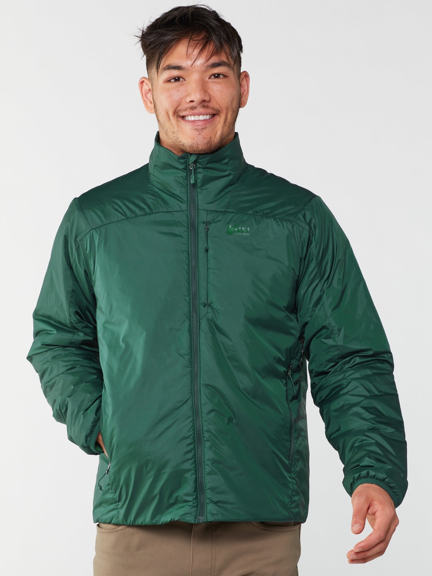 model in the green zip-up jacket